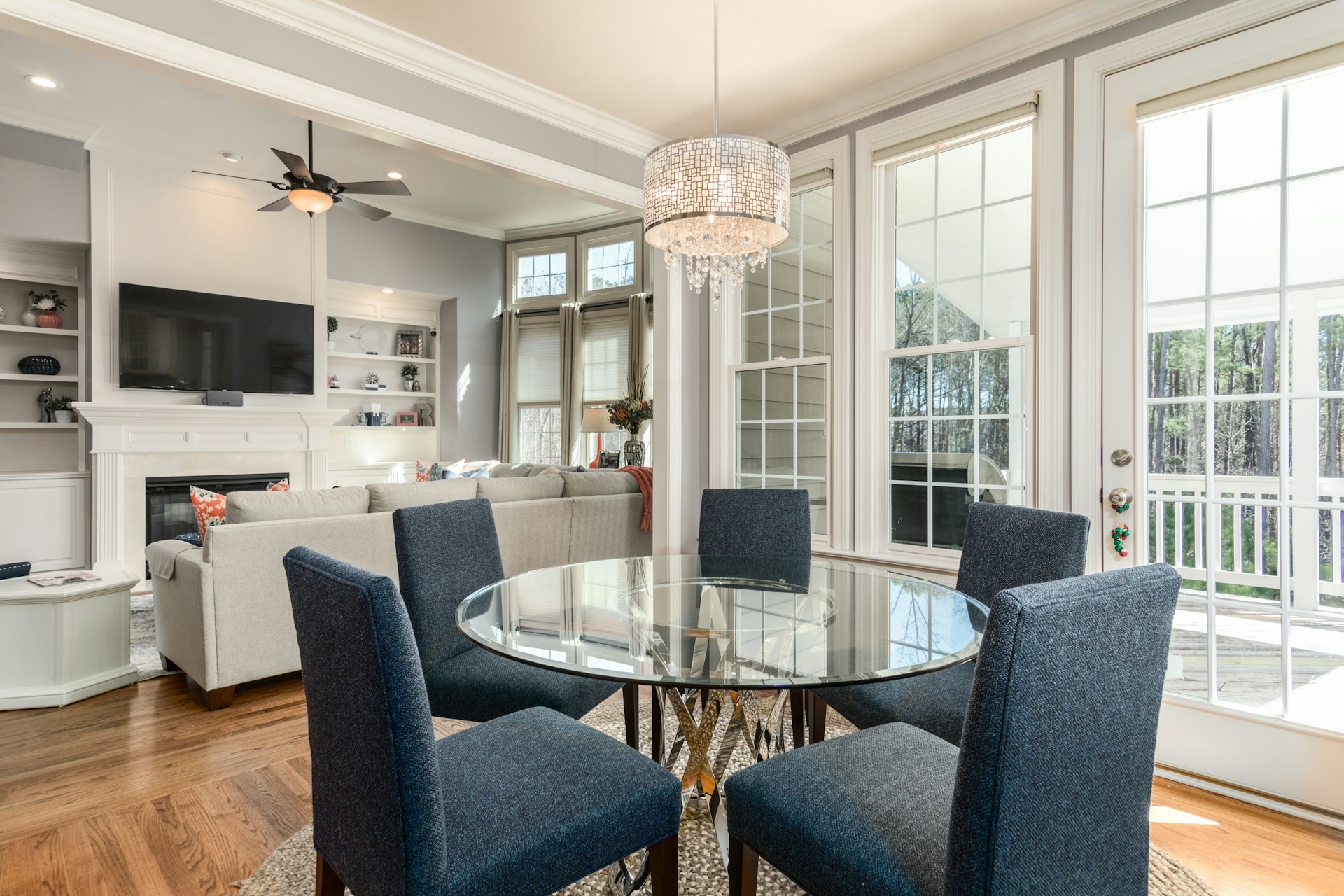 dining area with glass table and blue chairs