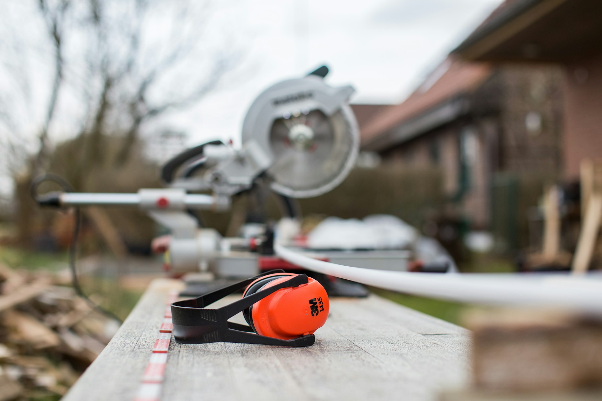 saw and ear muffs sitting on bench